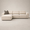 Modern beige sectional sofa with chaise and geometric pillow, luxury living room furniture