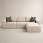 Beige L-shaped sectional sofa with geometric black and white pillows, modern luxury living room furniture