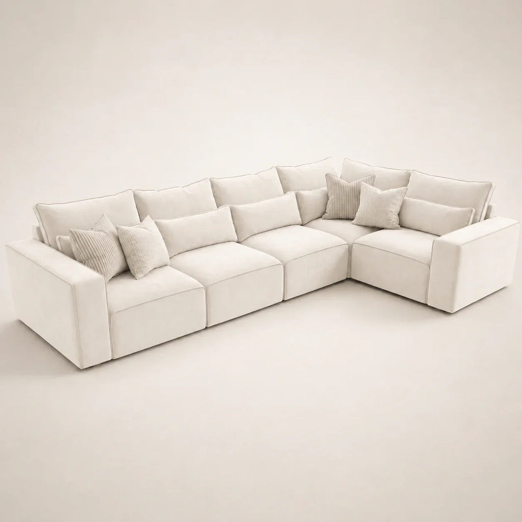 Luxury white sectional sofa with plush cushions and throw pillows, modern living room furniture