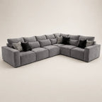 Large grey velvet sectional sofa with black and patterned throw pillows, modern luxury living room furniture