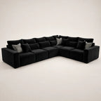 Black velvet L-shaped sectional sofa with patterned throw pillows, luxury living room furniture