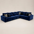 Luxury navy blue velvet sectional sofa with modular design and patterned throw pillows
