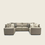 Luxury beige sectional sofa with geometric pillows, modern living room furniture