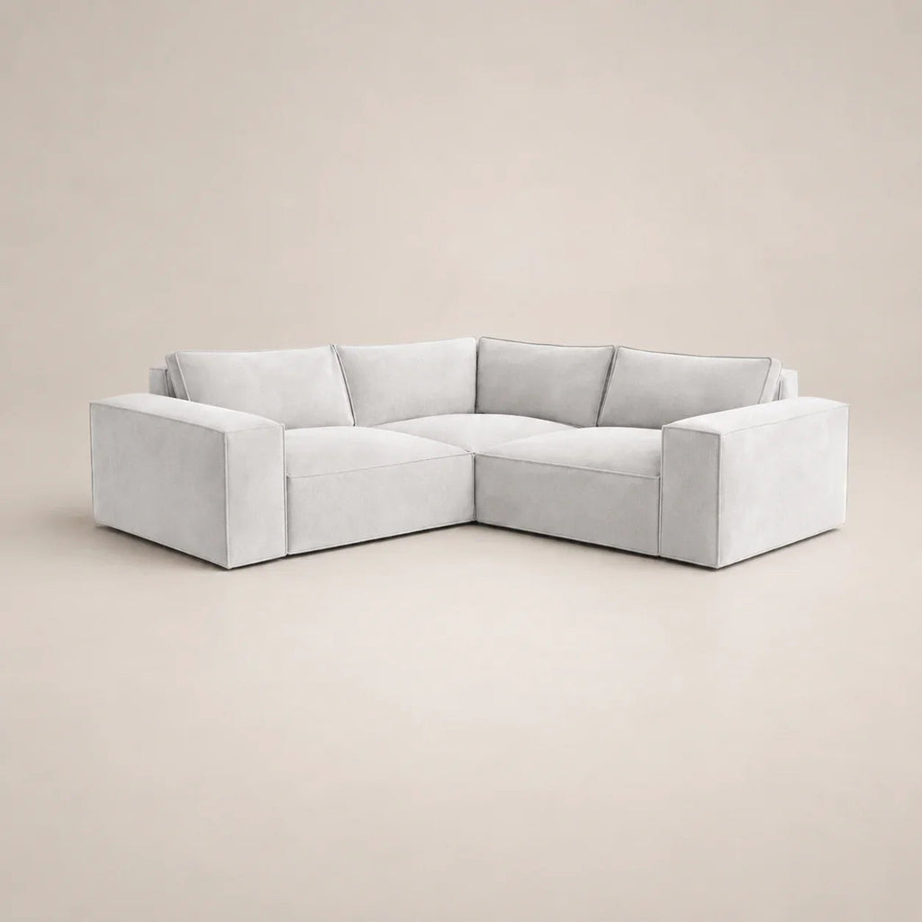 Modern light grey L-shaped sectional sofa with plush cushions, ideal for luxury living rooms