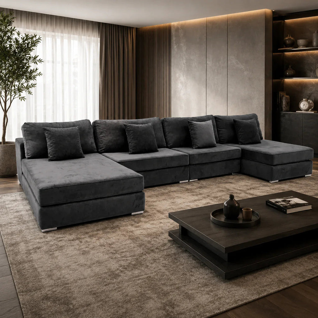 Luxury dark grey sectional sofa in modern living room with ambient lighting and wooden coffee table
