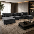 Luxury dark grey sectional sofa in modern living room with ambient lighting and wooden coffee table