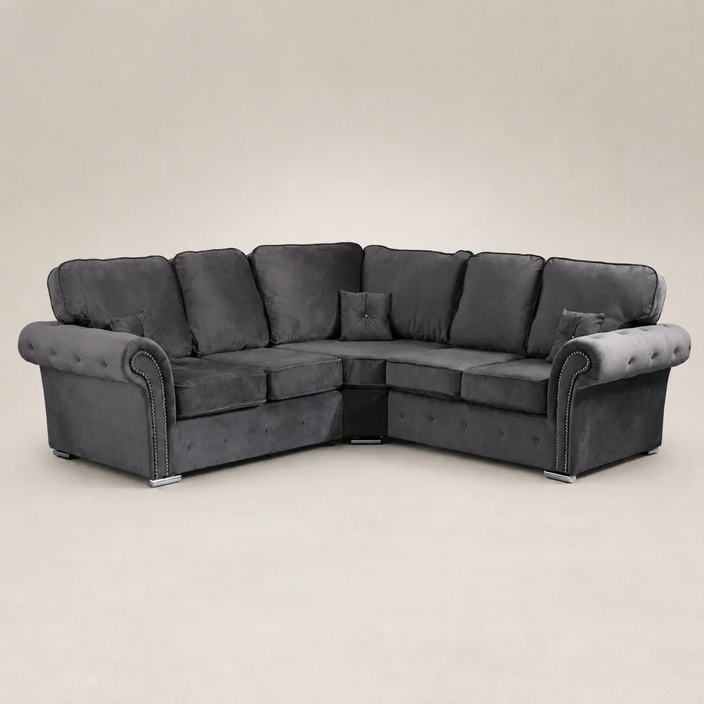 Luxury dark grey velvet corner sofa with tufted arms and nailhead trim, ideal for modern living rooms