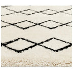 Cream shaggy rug with black diamond pattern, cozy living room floor decor