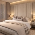 Luxury upholstered bed with tall panel headboard, neutral bedding, and ambient lighting in modern bedroom