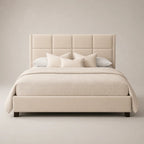 Luxury beige upholstered bed with tufted headboard, neutral bedding, and dark wood legs