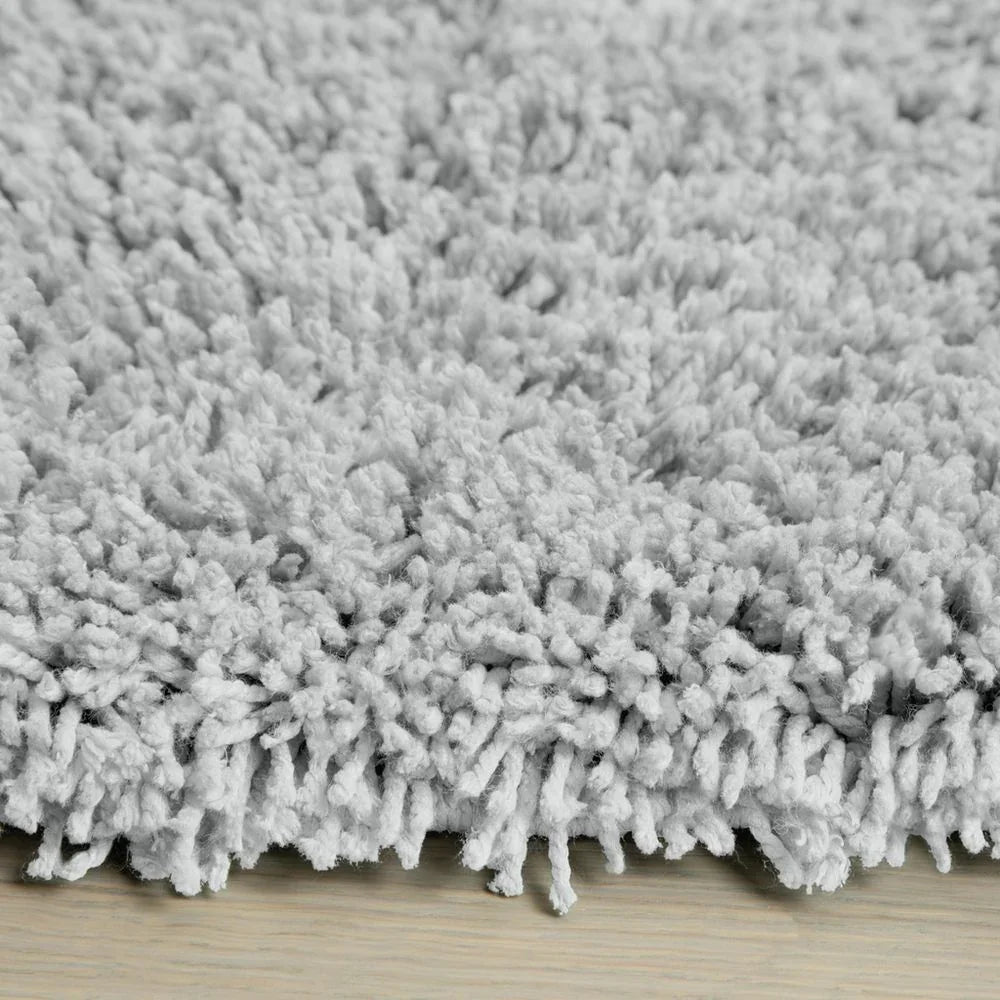 Soft grey shaggy rug on wooden floor, cozy luxury home decor