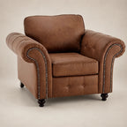 Brown leather armchair with nailhead trim, tufted back, and rolled arms for luxury living room seating