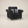 Black fabric armchair with rolled arms, nailhead trim, and plaid pillows for luxury living room seating