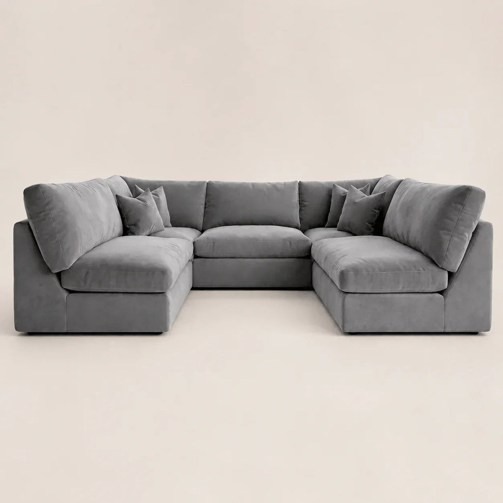 Gray velvet sectional sofa with chaise lounges and plush cushions, modern luxury living room furniture