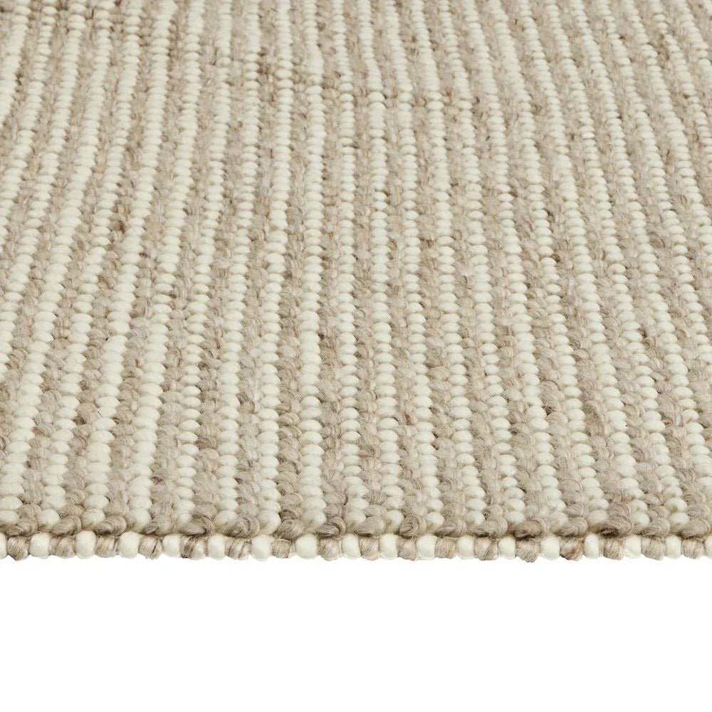 Cream and beige striped woven rug with textured loop pile, ideal for living room or bedroom decor.