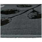 Grey area rug with black floral pattern, soft textured pile and stitched edge for modern living rooms