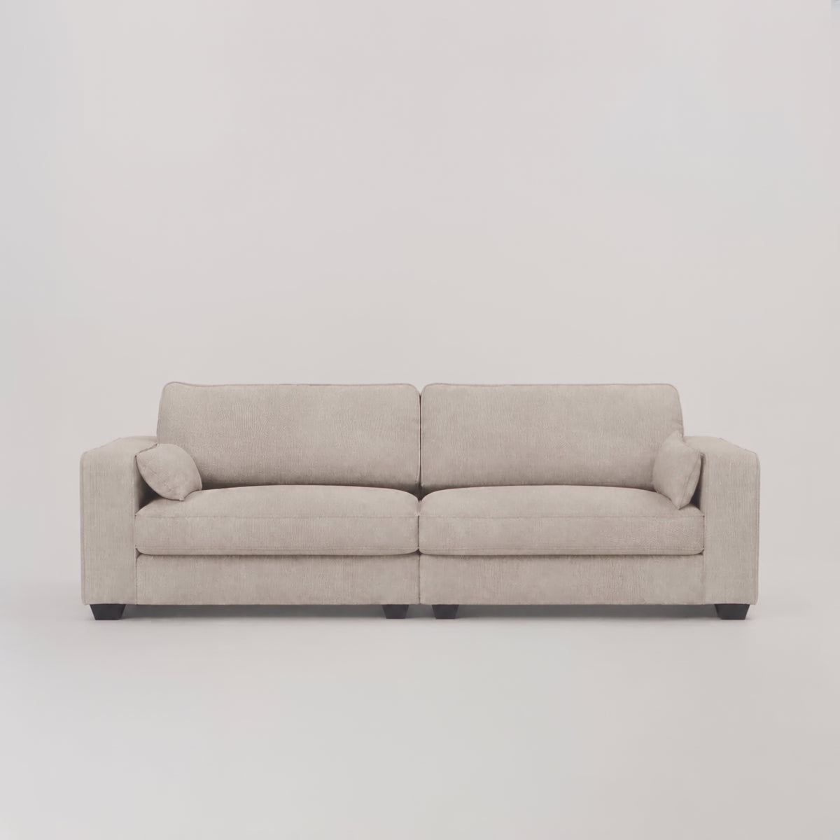 Verdi Large Sofa in Summer Beach — frontal studio scale demonstration with model walking left to right
