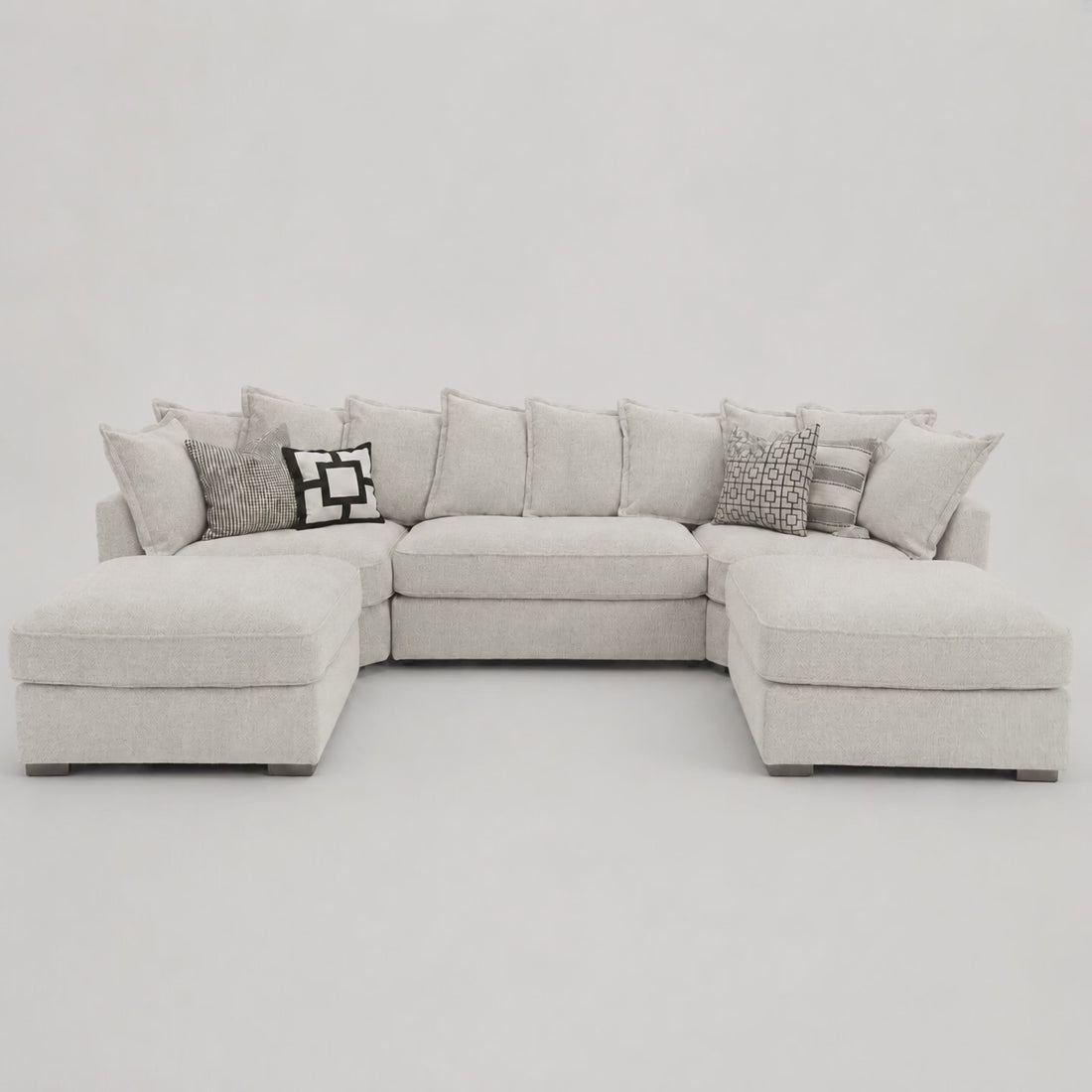 Primrose U Shape Sofa in Crimsy Truffle — frontal studio demonstration with seated model for scale
