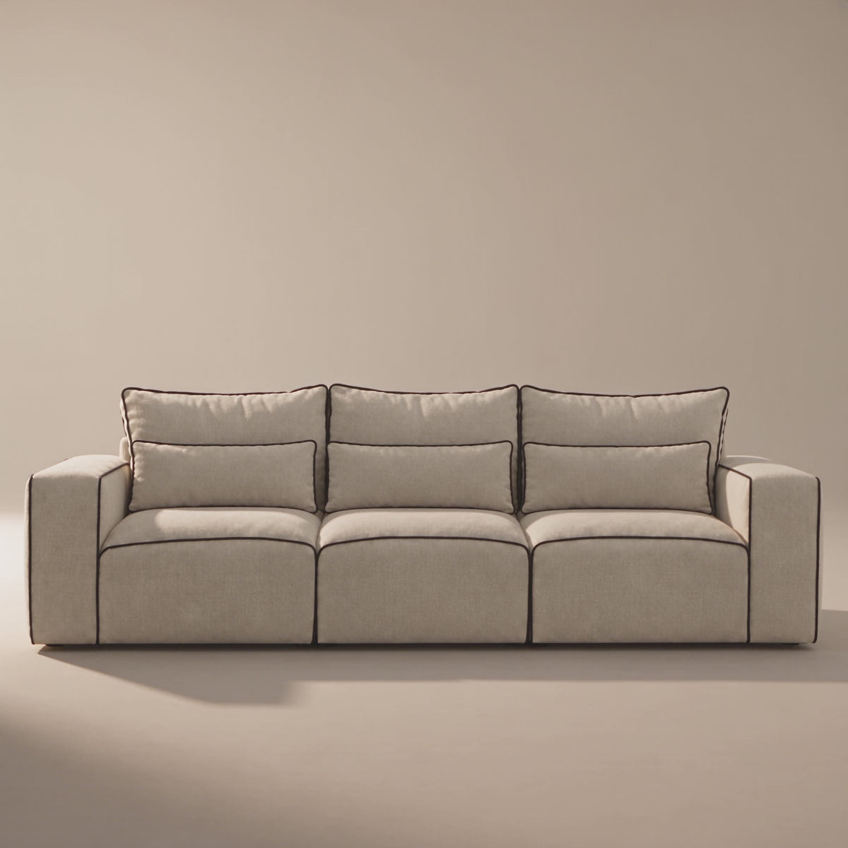 Maison XL Sofa in a minimal studio with an adult model demonstrating scale