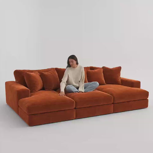 Aria Cinema Sofa Large 330 cm in Plush Burnt Orange — five-second white studio video with seated model showing scale and equal cinema seat depth