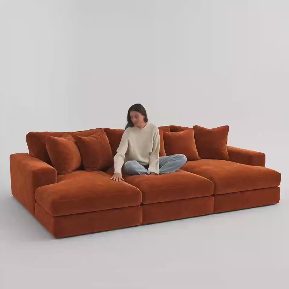 Aria Cinema Sofa Large 330 cm in Plush Burnt Orange — five-second white studio video with seated model showing scale and equal cinema seat depth