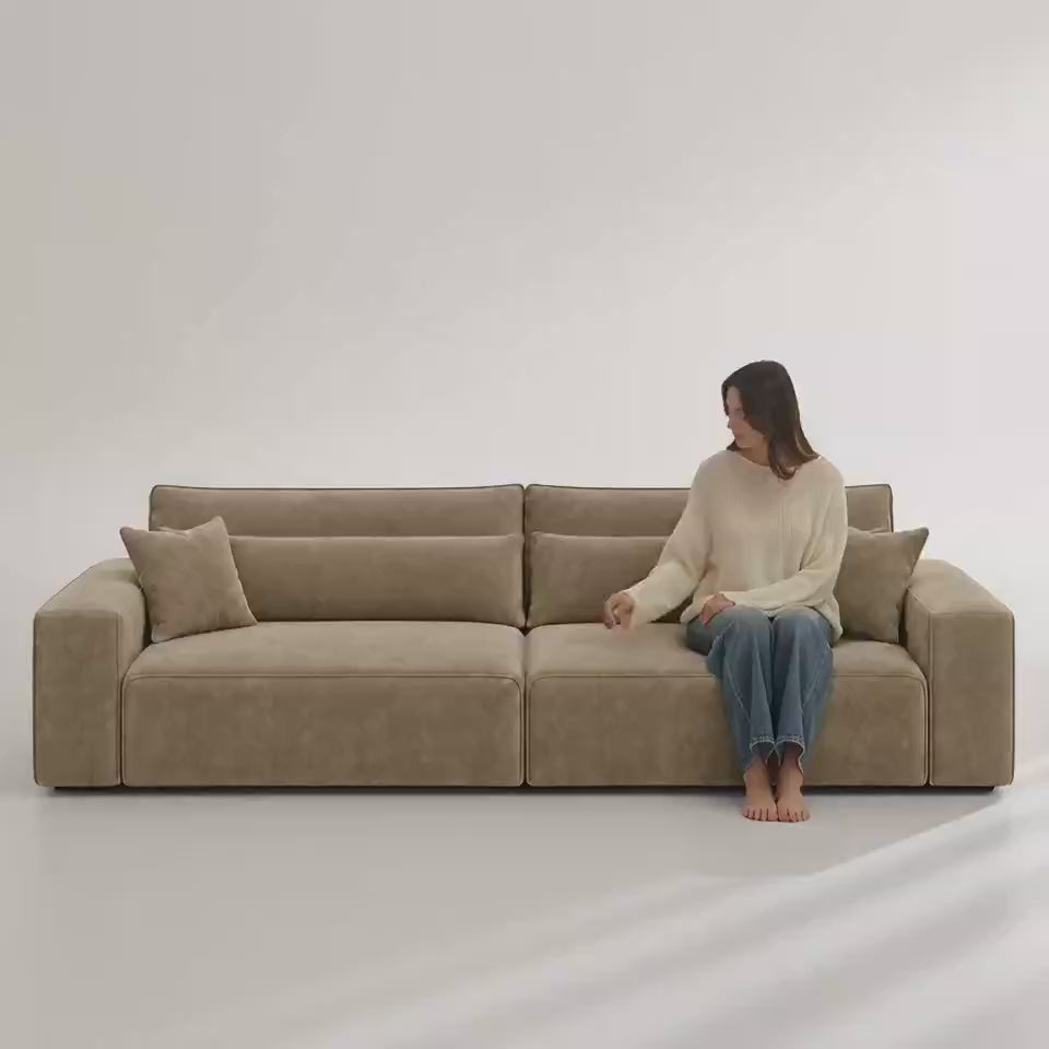 Dalton 4 Seater Sofa in Champagne Mink — five-second white studio video with seated model showing scale and upholstery