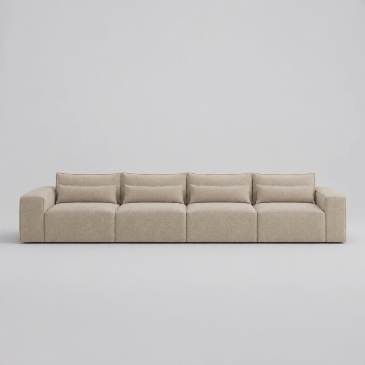 Maison XXL Modular Sofa in a minimal studio with an adult model demonstrating scale