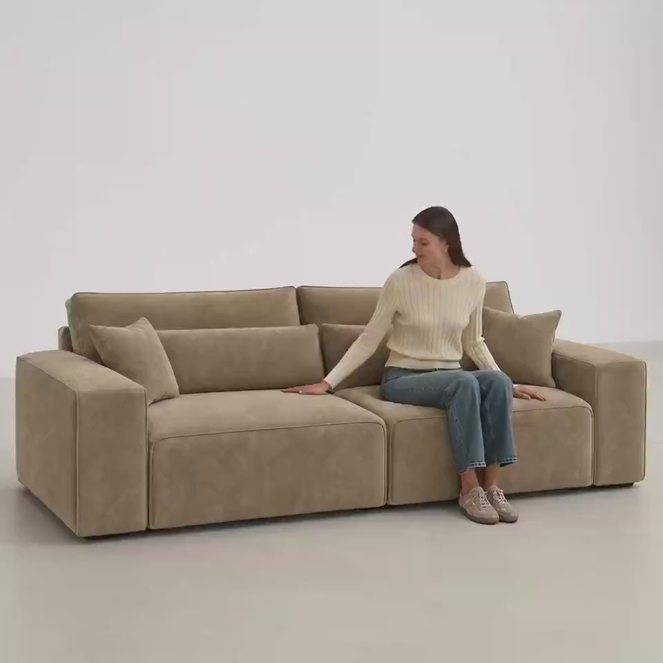 Dalton 3 Seater Sofa in Champagne Mink — five-second white studio video with seated model showing scale and upholstery