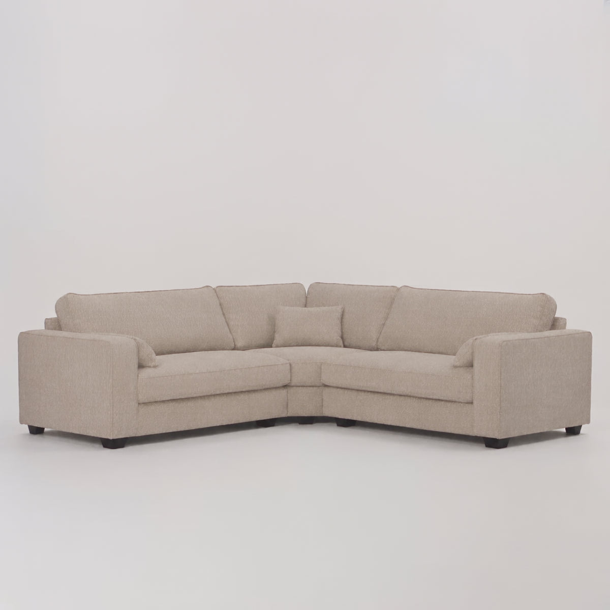 Verdi XL Double Corner Sofa in Summer Beach — frontal studio scale demonstration with model walking left to right