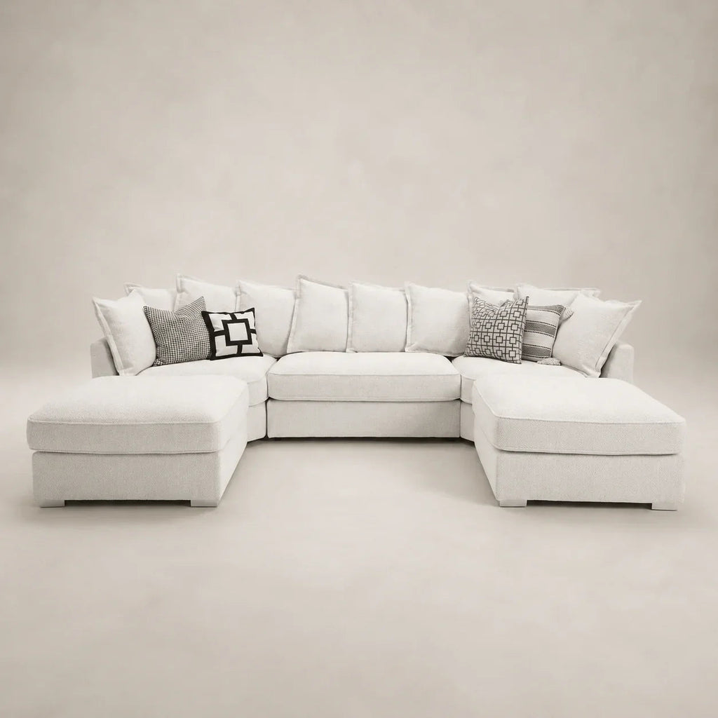 Luxury white sectional sofa with chaise lounges and patterned throw pillows, perfect for modern living rooms.