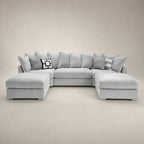Luxury grey sectional sofa with chaise lounges and patterned cushions, ideal for modern living rooms.