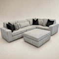 Luxury grey sectional sofa with black and patterned cushions, ideal for modern living rooms