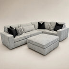 Luxury grey sectional sofa with black and patterned cushions, ideal for modern living rooms