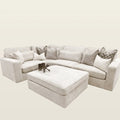 Luxury beige sectional sofa with matching ottoman and decorative pillows, perfect for modern living rooms.