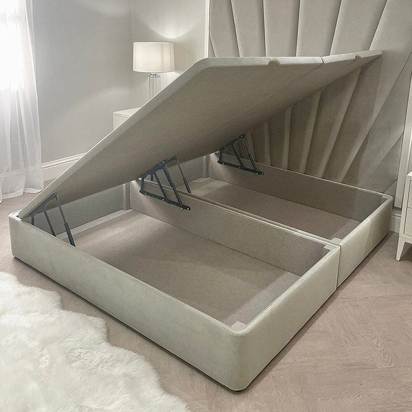 Smoke velvet ottoman bed base with lift-up storage in a modern bedroom setting