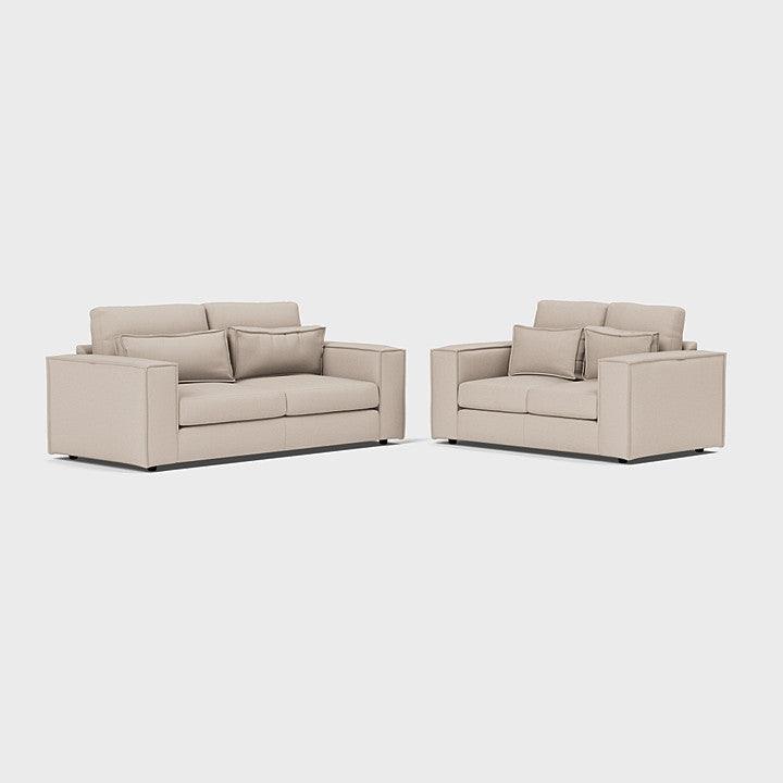 Modern beige 3-seater and 2-seater sofa set with cushions on a plain background