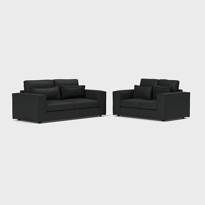 Modern black 3-seater and 2-seater sofa set with matching cushions on white background
