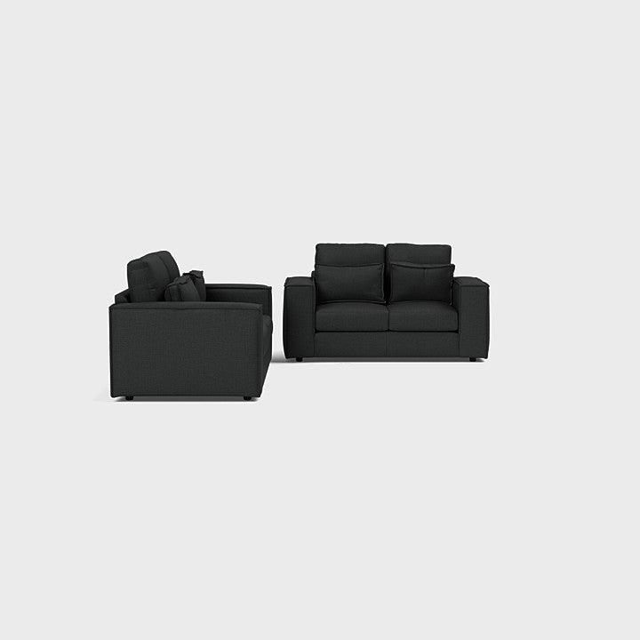 Modern dark grey 3-seater and 2-seater fabric sofa set with plush cushions on light background