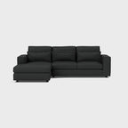 Modern dark grey corner chaise sofa with wide armrests and plush back cushions on white background