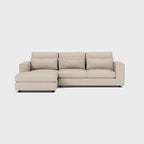 Modern beige corner chaise sofa with wide armrests and plush cushions on a white background