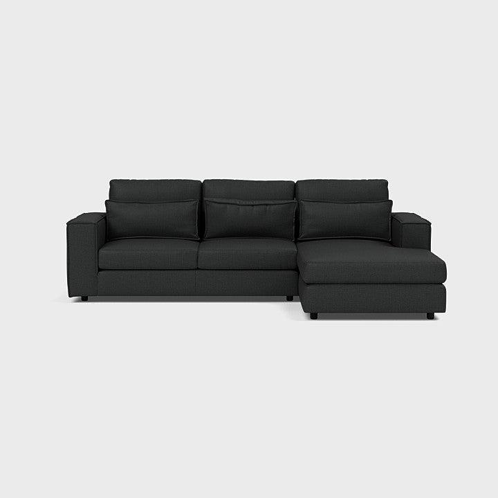 Modern dark grey corner chaise sofa with right-hand lounger on a light background