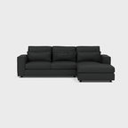 Modern dark grey corner chaise sofa with right-hand lounger on a light background