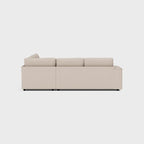 Modern beige double corner sofa with clean lines, shown from the back on a white background