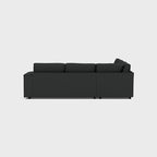 Modern dark grey double corner sofa with clean lines, photographed from side view on white background