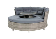 Circular outdoor wicker sofa with grey cushions and central table, perfect for garden lounging