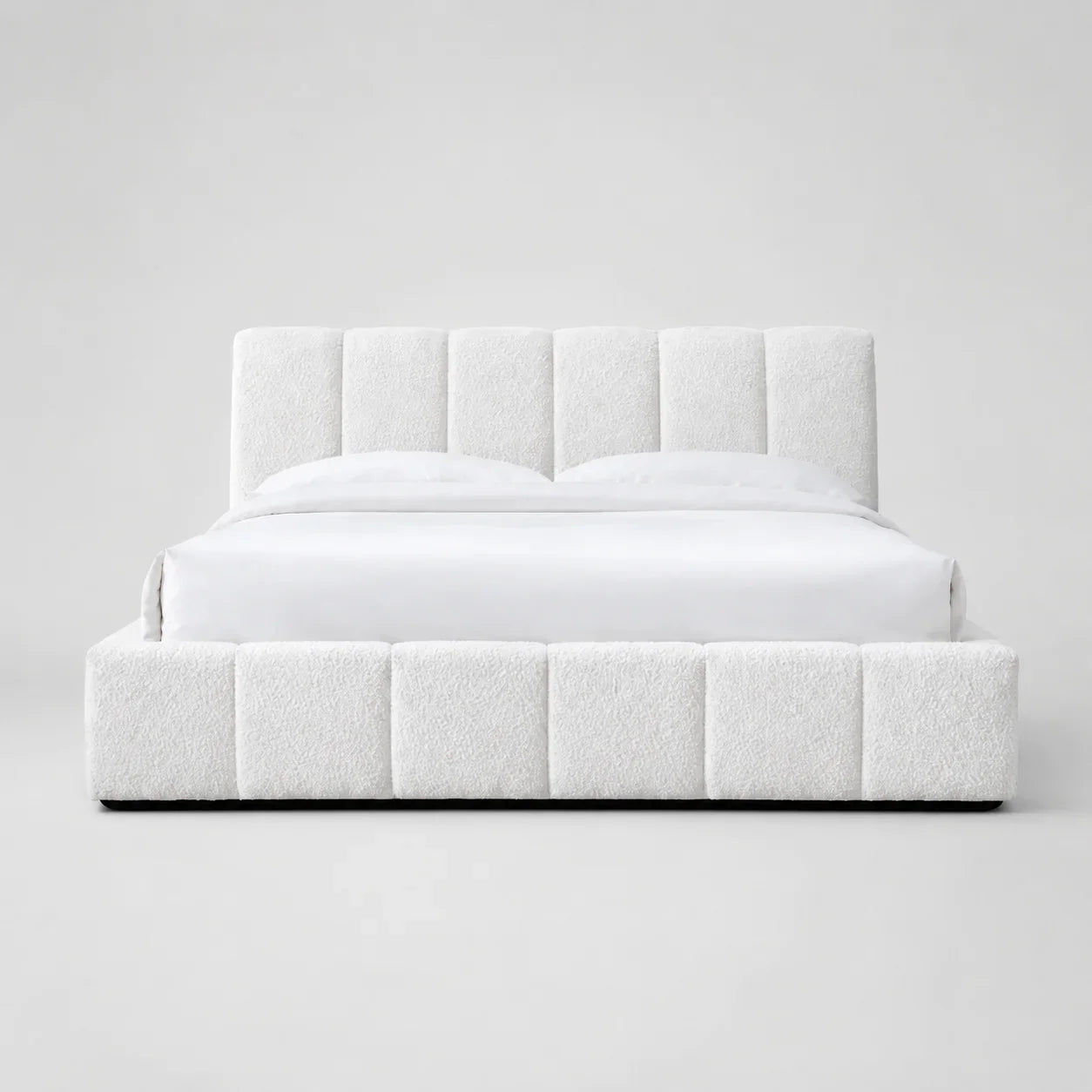White luxury upholstered bed with tufted headboard and base, modern bedroom furniture