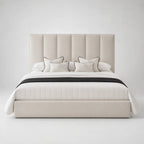 Luxury beige upholstered bed with tufted headboard, white bedding, and black trim accents