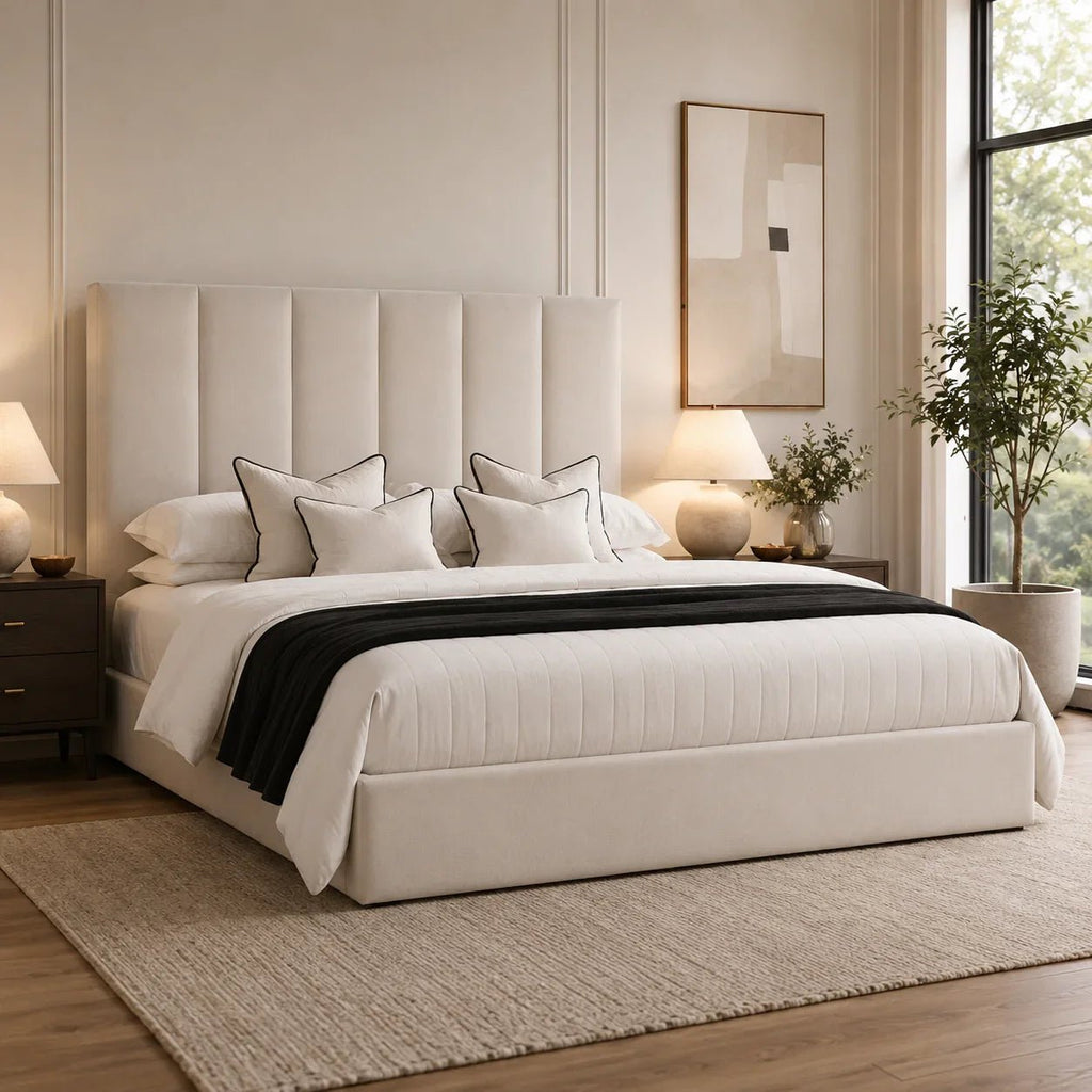 Luxury upholstered bed with tufted headboard, white bedding, and black throw in modern bedroom