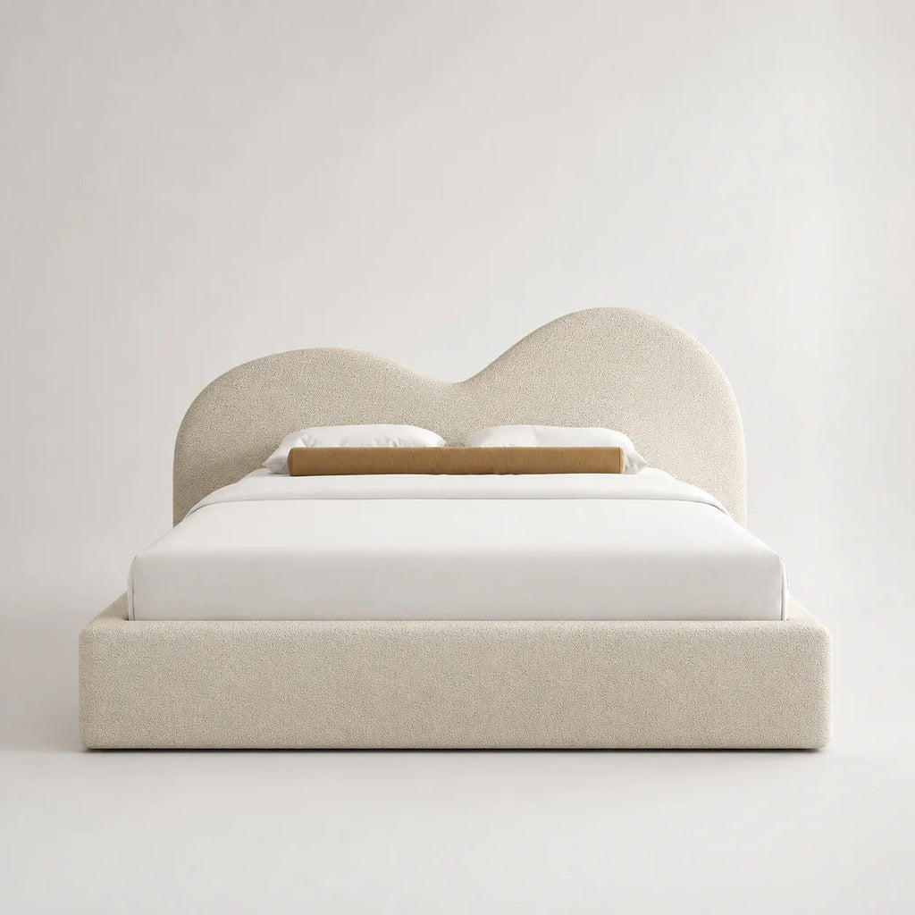 Luxury upholstered bed with curved headboard, white bedding, and beige textured fabric