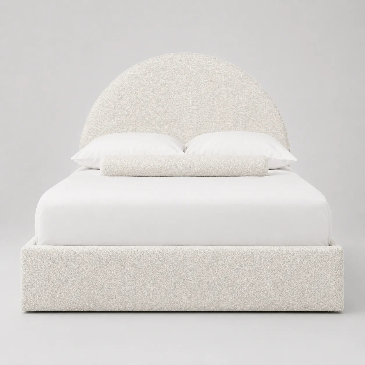 Luxury upholstered bed with curved headboard, white bedding, and textured fabric for modern bedroom